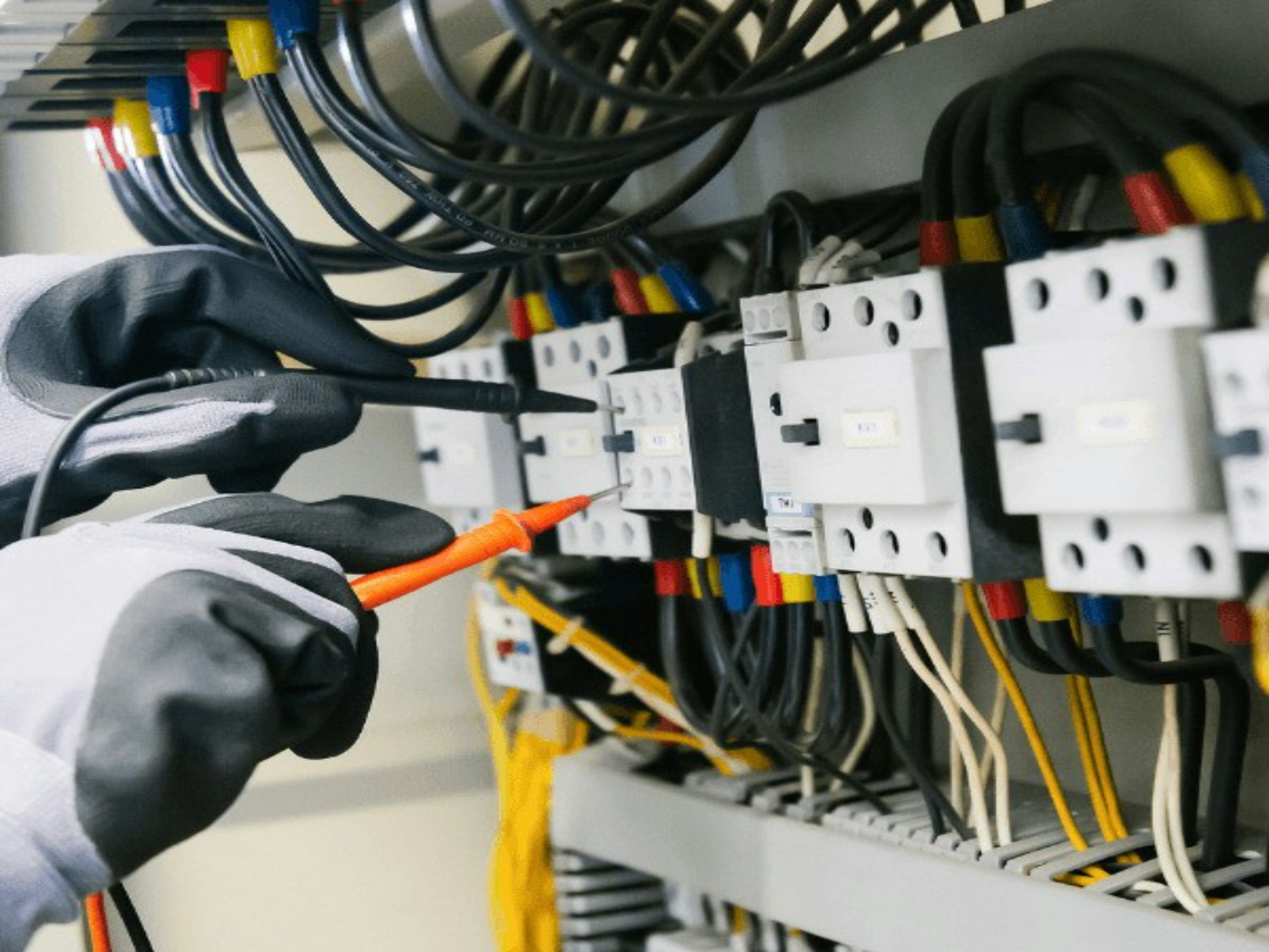 Electrician testing an electrical panel