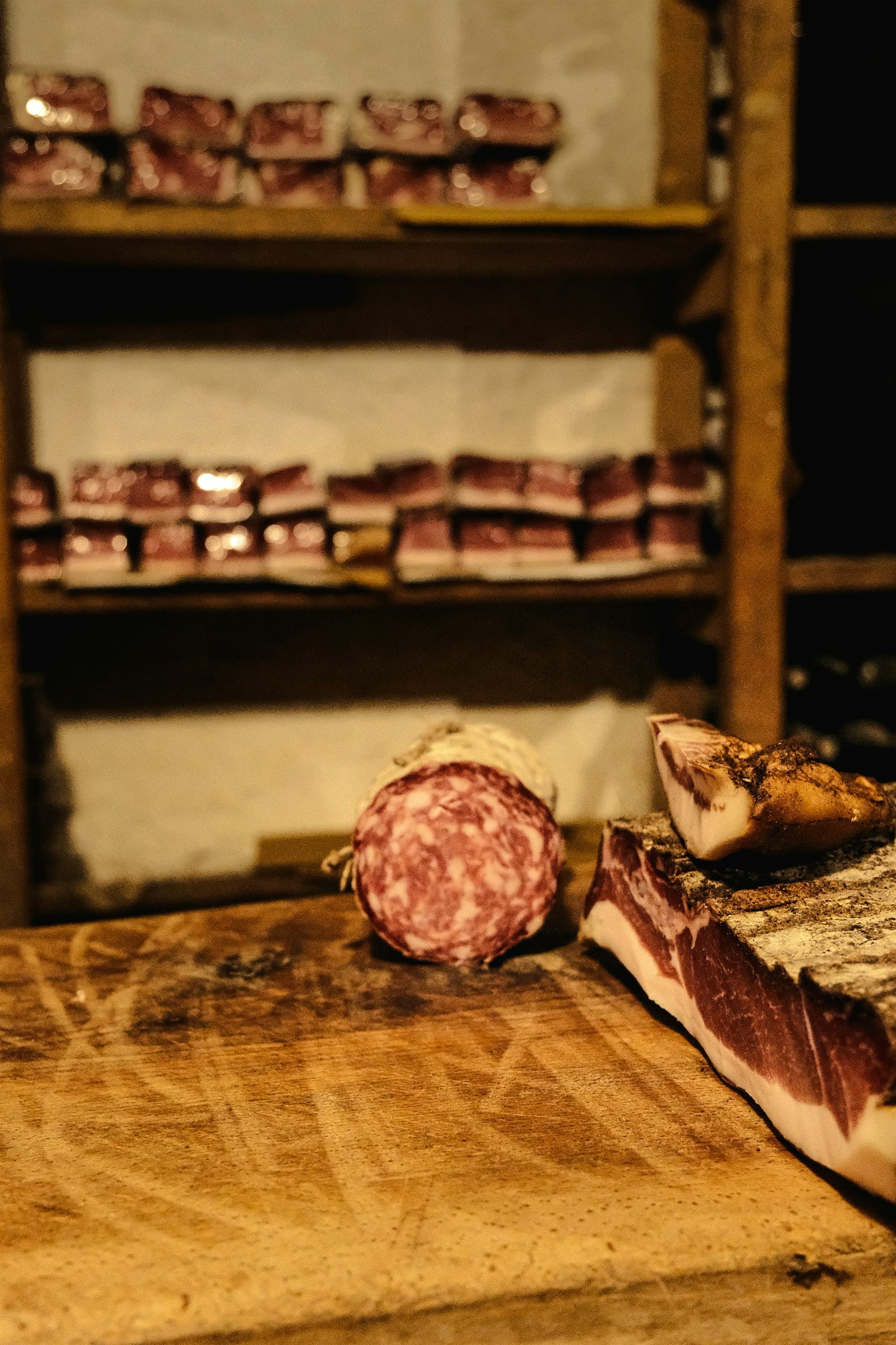 Cured Italian meats and salami on a wooden counter