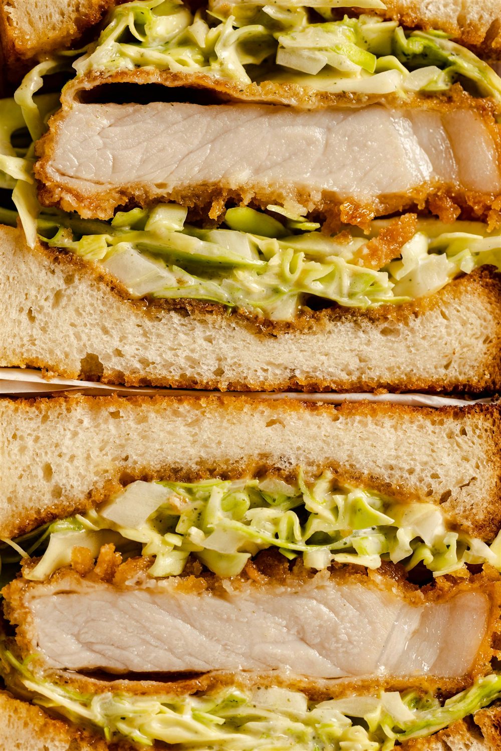 Breaded chicken cutlet hero, sliced to show layers