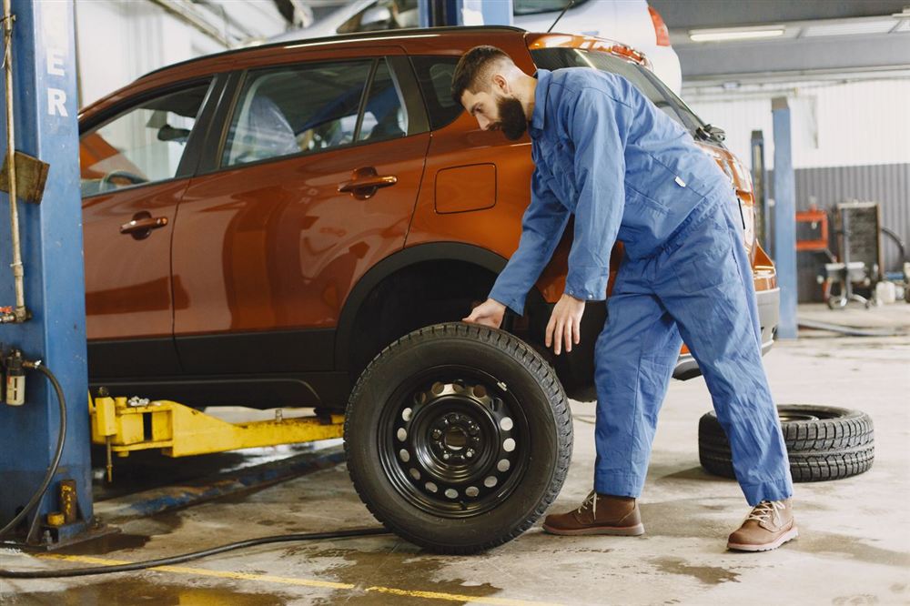 Mechanic replacing a tire in the shop