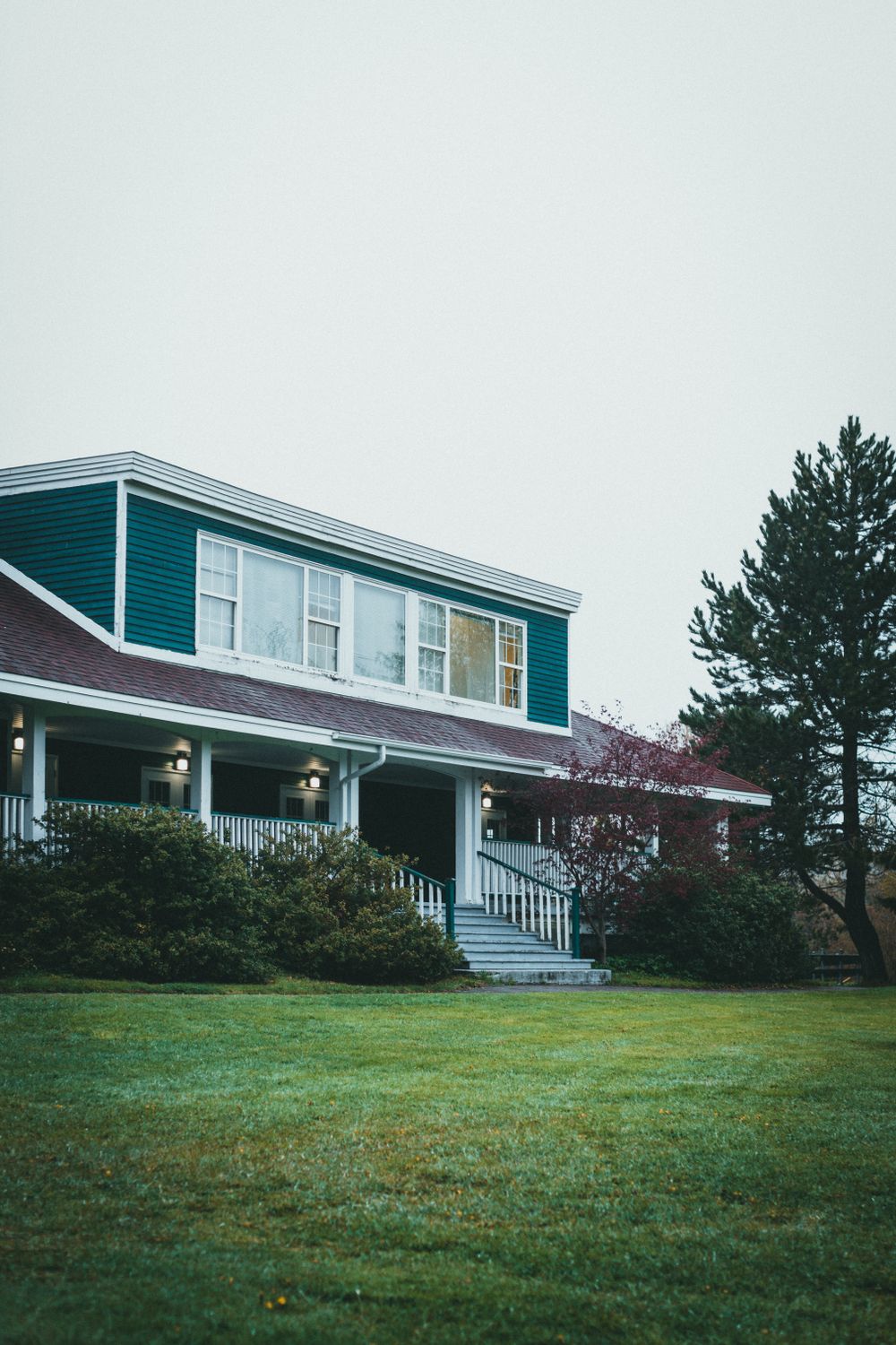 Home with a wraparound porch and a wide green front lawn