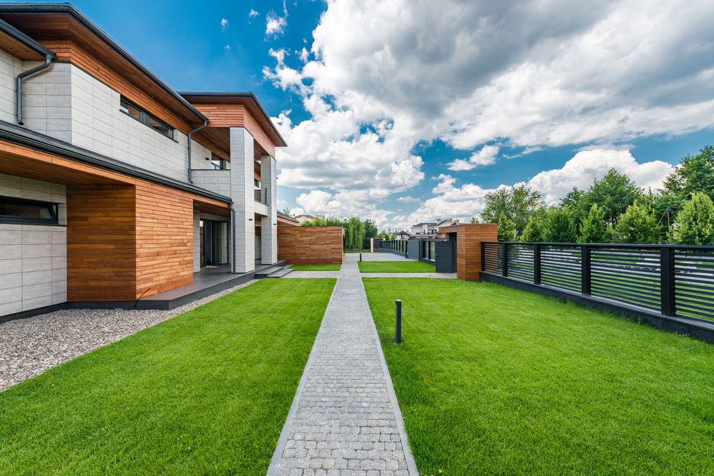 Modern home with a striped, freshly mowed green lawn